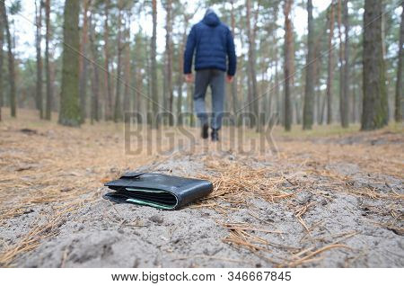 Young Man Loses His Purse With Euro Money Bills On Russian Autumn Fir Wood Path. Carelessness And Lo