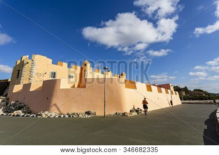 Oeiras - August 27, 2019: Man Exercising At Sunrise In Front Of The Fort Of Sao Joao Das Maias, Buil