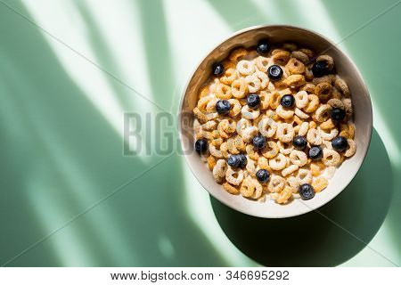 Deliscious Healthy Breakfast With Flakes And Fruits Isolated On Green Background.muesli With Yogurt 