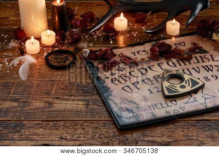 Mystic Ritual With Ouija And Candles. Devil's Board Concept, Black Magic Or Fortune Telling Rite Wit