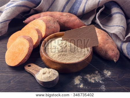 Sweet potato flour in a wooden bowl isolated on a white background
