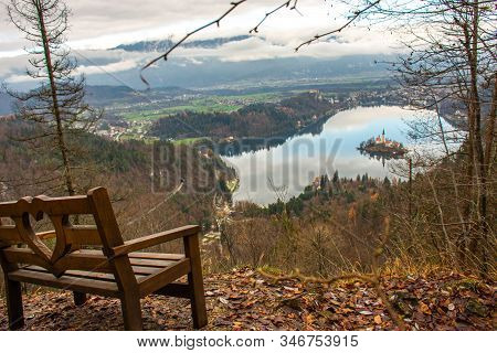 View Of Lake Bled In Slovenia From The Viewpoint On Mount Velika Osojnica Next To A Wooden Bench On 