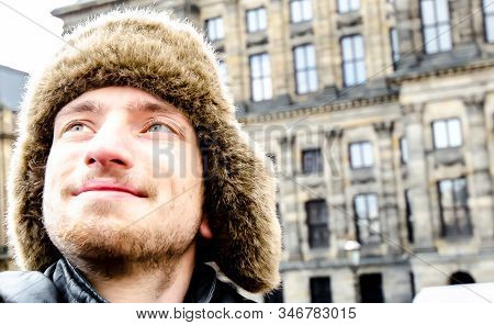 Amsterdam / Netherlands 18th January 2020 : An Young Man With Wollen Fur Hood Looking Up At Amsterda