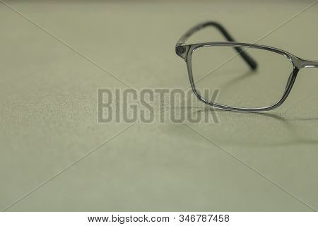 Clear Plastic Glasses, Eyes Closed, Shot Close-up, On A Blurred Green Background. Concept: Beautiful