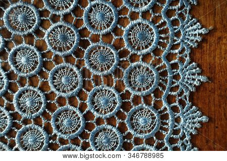 Edge Of Light Blue Crochet Lace On Wooden Table