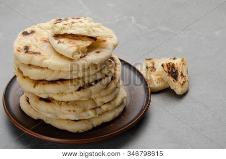 Homemade Tasty Traditional Pita Bread Stacked In Clay Dish On Stone Kitchen Table