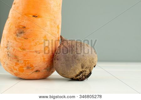 Ugly Vegetables. Carrots And Beets On A White Wooden Background. The Form Does Not Affect The Taste,