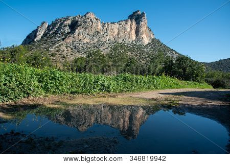 Famous Pentadaktylos Rocky Mountain Peaks Reflected On Water  In  Kerynia Town In Cyprus Late In The