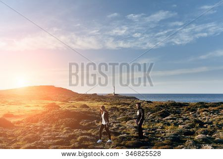 Yoong And Happy Couple Walking With Seaview And Lighthouse On Background