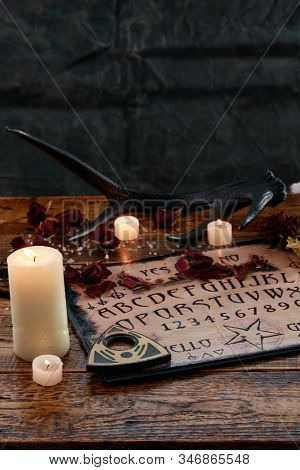 Mystic Ritual With Ouija And Candles. Devil's Board Concept, Black Magic Or Fortune Telling Rite Wit