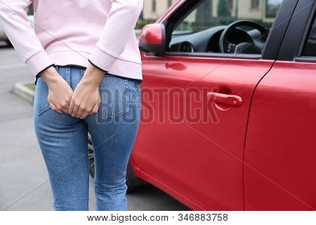 Woman Suffering From Hemorrhoid Pain Outdoors, Closeup