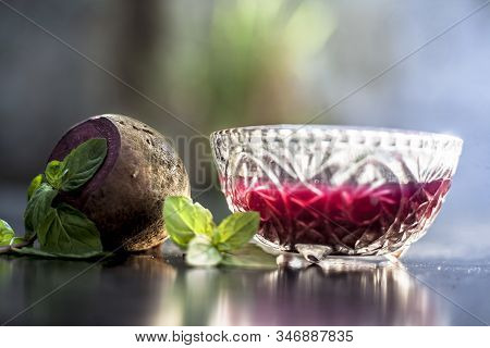 Detoxifying Beetroot Extracted Tincture In A Glass Bowl On Black Glossy Surface With Some Raw Fresh