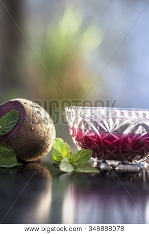 Detoxifying Beetroot Extracted Tincture In A Glass Bowl On Black Glossy Surface With Some Raw Fresh