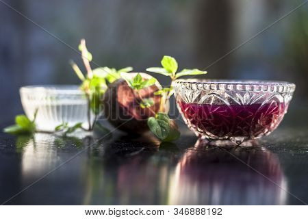 Home Remedy For Dandruff On Wooden Surface I.e., Beetroot Stock Well Mixed With Water In A Glass Bow