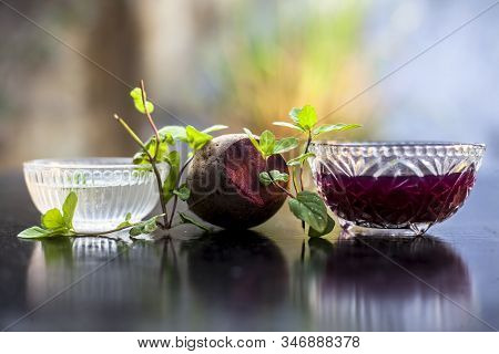Home Remedy For Dandruff On Wooden Surface I.e., Beetroot Stock Well Mixed With Water In A Glass Bow