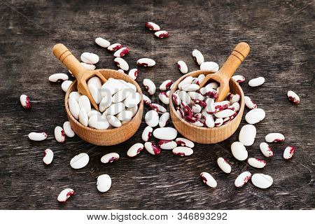 Colored Beans In Wooden Cups On A Dark Wooden Background