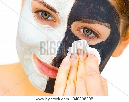 Woman With Clay Carbo Black Mask On One Half Face And White Mud On Second Half. Girl Removing Cosmet