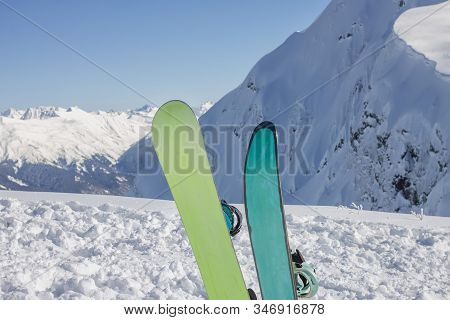 Two Snowboards Stands On The Background Of The Snowy Mountains Of The Caucasus, The Ski Resort Rosa 