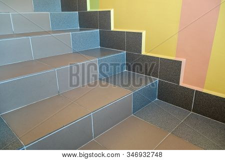 Wide Staicase Covered With Ceramic Tiles Indoors In A House Interior.