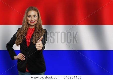 Love Netherlands! Happy Cute Woman Smiling And Showing Thumb Up On Netherlandish Flag Background
