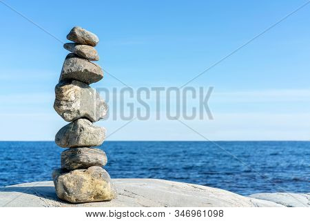 Stacked Rocks Balancing, Stacking With Precision. Stone Tower On The Shore. Copy Space.