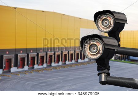 Closed Circuit Camera Multi-angle Cctv System Against The Background Of A Modern Warehouse Complex.