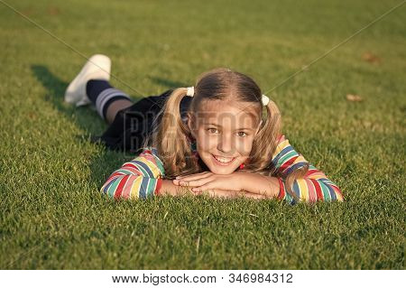Living Happy Life. Cheerful Schoolgirl On Sunny Day. Happy Smiling Pupil. Have Fun. Girl Kid Laying 