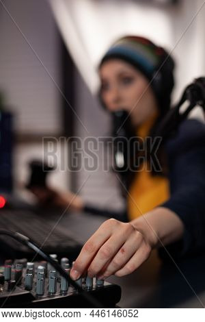 Close Up Of Woman Using Streaming Equipment Live With Headphones And Microphone. Gamer Talking To Au