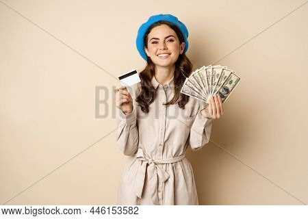 Microcredit And Money Concept. Young Stylish Woman Showing Credit Card And Dollars Cash, Smiling Hap