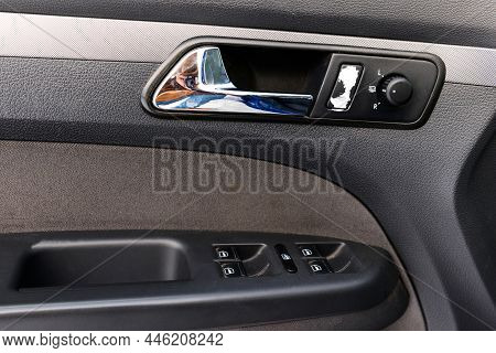 Inside The Drivers Door Of A Car With A Window Lifter. Car Door Handle. Automatic Adjustment Of Mirr