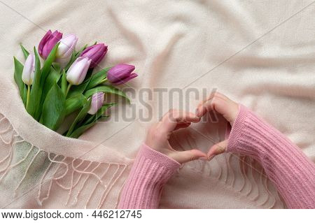 Spring Flat Lay With Female Hands Showing Heart Sign And Bunch Of Tulips On Cream, Beige Textile Bac