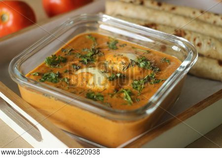 Egg Butter Masala Served With Indian Flatbread Smothered With Ghee.