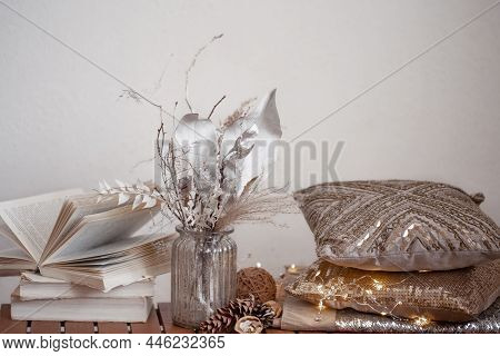 Cozy Background With Books, A Vase Of Dried Flowers And Decorative Cushes.