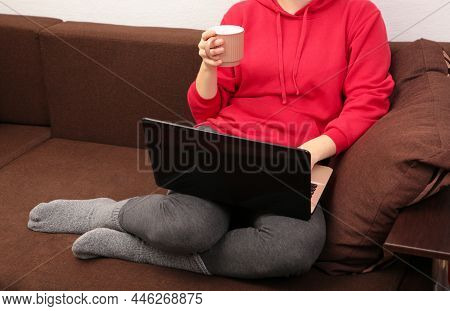 Woman Sit On Cozy Sofa Writing Email On Laptop And Drinking Coffee, Girl Freelancer Working At Compu