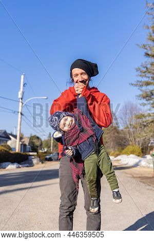 Fun And Playful Moment With Father And Son Outdoors. Goofing Around As Dad Lift Three Year Old Boy F