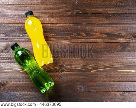Isotonic Energy Drink With L-carnitine. Bottles With Yellow And Green Transparent Liquid. L-carnitin