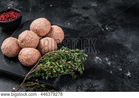 Raw Vegan Meatballs From Plant Based Meat With Thyme. Black Background. Top View. Copy Space