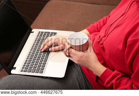 Woman Sit On Cozy Sofa Writing Email On Laptop And Drinking Coffee, Girl Freelancer Working At Compu