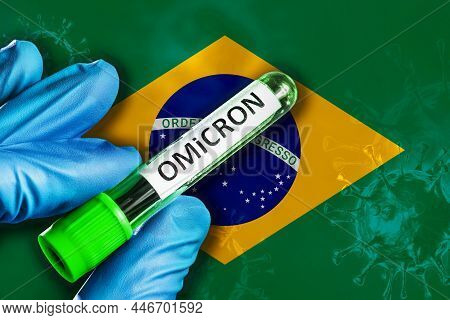 Brasil Outbreak Of Omicron Variant. Hand Holds A Test Tube With Covid-19 Virus Omicron In Front Of B