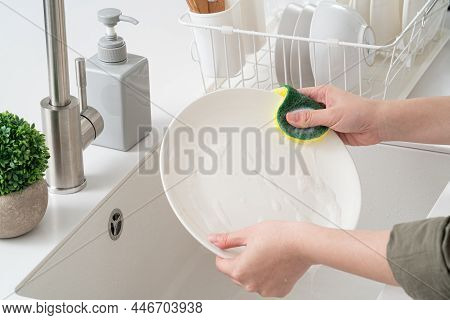 Woman Housewife Is Doing The Dishes At Home Kitchen.