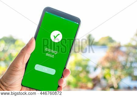 A Man's Hand Holds A Smartphone On The Screen With The Message Money Sent. Concept Of Financial Tran