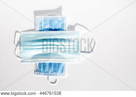 Mask Is Placed On Top Of Each Other Like A Plus Sign On A White Background.  A Concept Mask That Hel