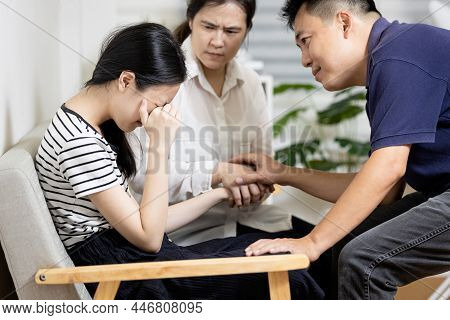 Asian Parents Give Advice,talk Sharing Thoughts Care To Teenage Girl,mom And Dad Holding Hands To Co