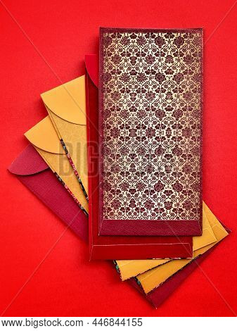 Colorful Chinese New Year Envelopes With Red Background. Happy Chinese New Year Concept.