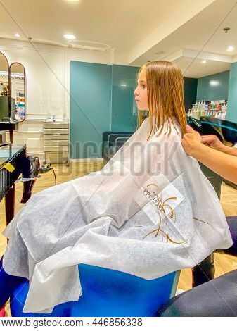 Saint - Laurent - Du Var, France - 19.10.2021: Hairdresser Making A Hair Style To Little Girl In Hai