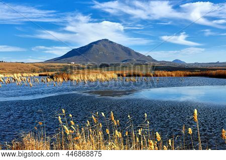 Nameless Lake On The Background Of Blue Sky And Mountains Of Caucasian Mineral Waters. The Bull And 