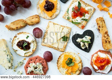 A Flat Lay Food Background Of A Selection Of Cheese And Crackers As An Apperitif Or Snack With Garni