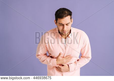 Portrait Of Sick Young Man Feeling Sudden Stomach Pain, Severe Abdominal Distress, Suffering Nausea 