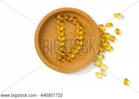 Yellow Oil Capsules With Vitamin D3Forming Shape D On The White Background. - Image