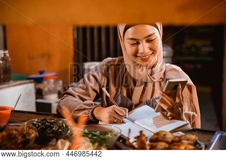 Muslim Woman Write A Report Of Her Food Business
